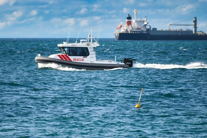 a small boat is in the water next to a larger boat