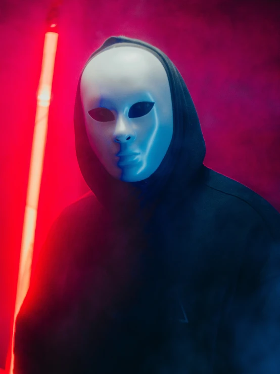 man in white mask with blue light saber