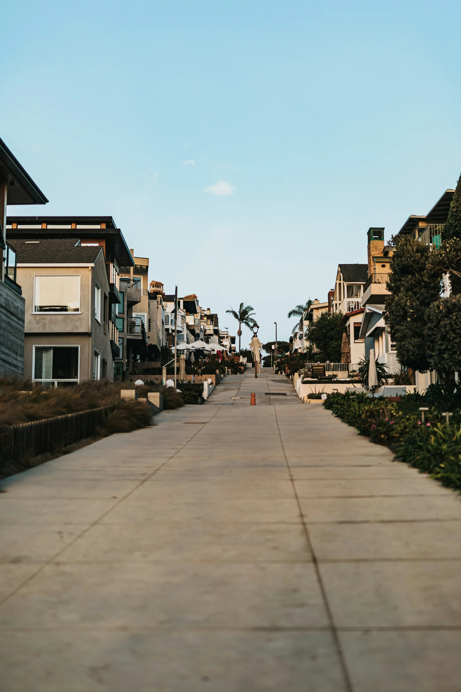 a road that has several buildings and houses on each side