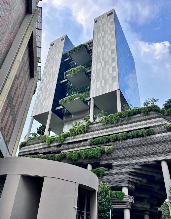 a building with multiple levels with plants on it