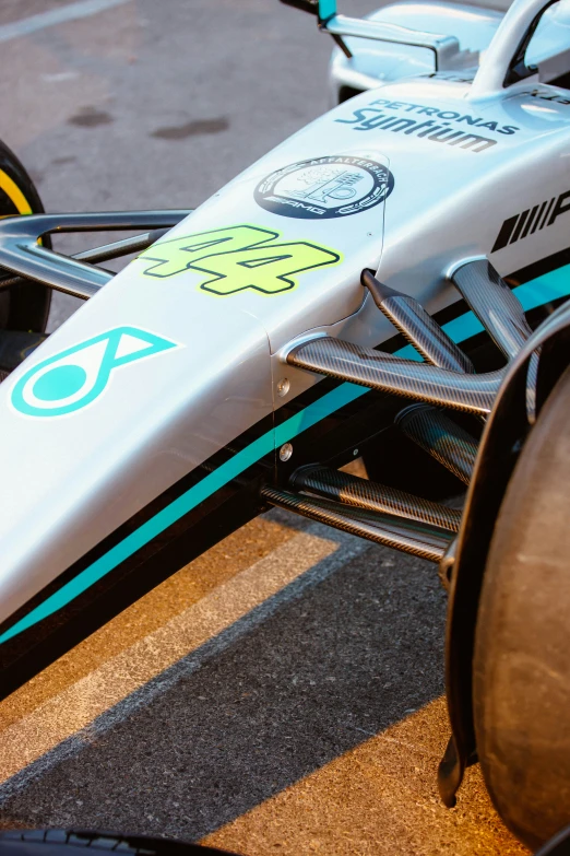 the front wheels of a race car sitting on the side of a parking lot