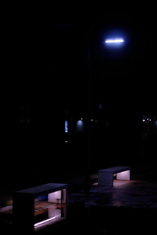 some benches on one side and lights above them