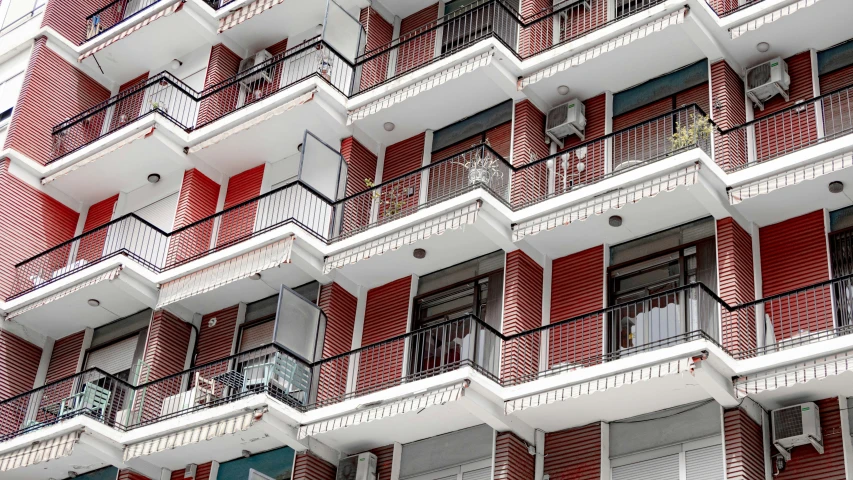 a large red building that has a bunch of balconies on it