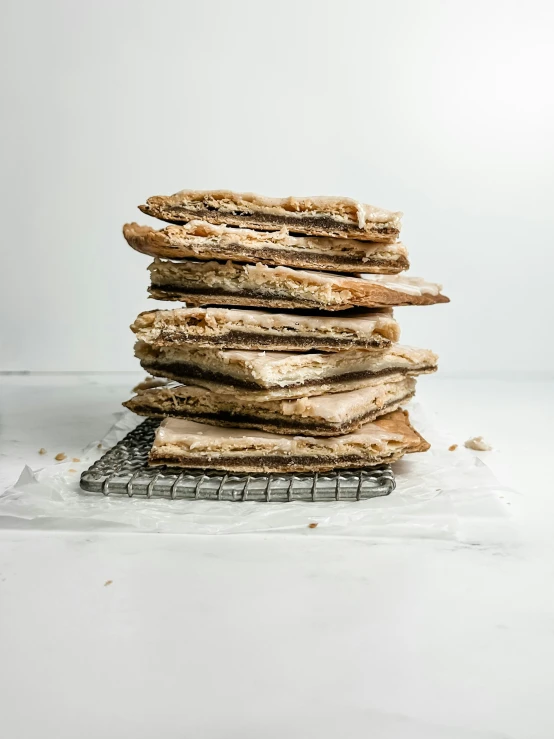 stack of food items with some baking mittens on wire rack