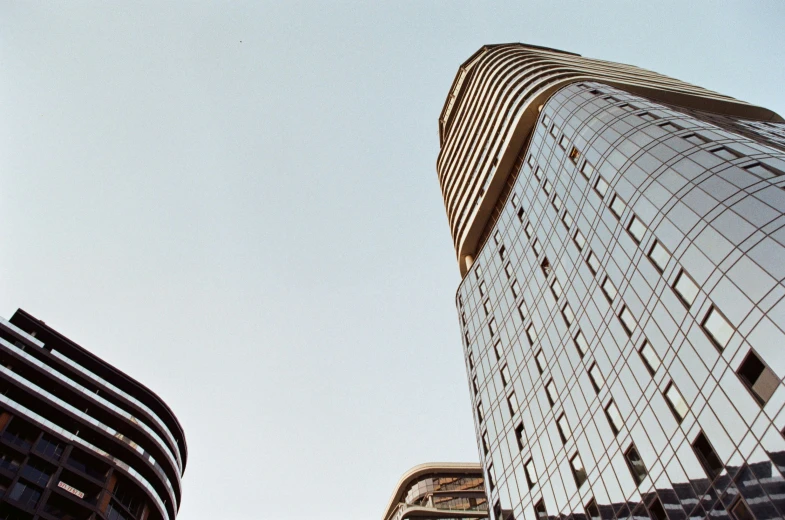 two tall buildings stand next to each other