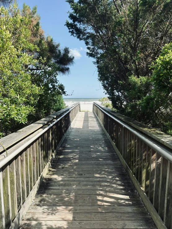 a small bridge crosses into the water on an overcast day