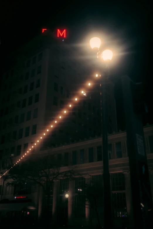 a very tall building next to a lit up sign