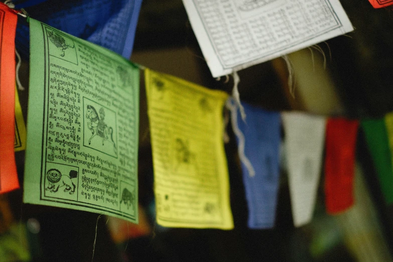 colorful, hanging cloths with writing on them