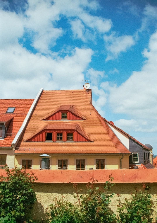 a house on a street with some green trees