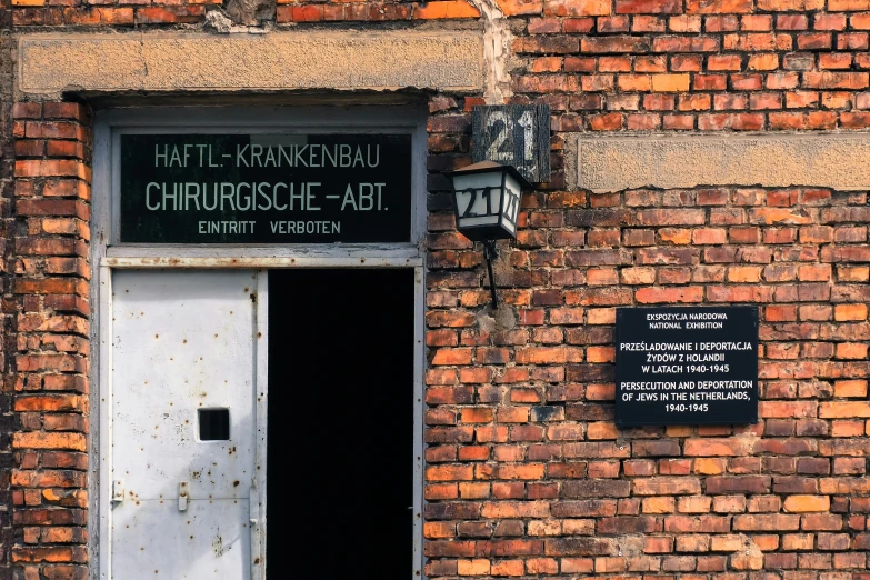 a door and plaque on the wall of an old building