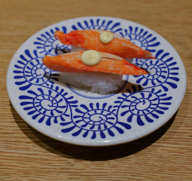 a white plate topped with lots of sushi