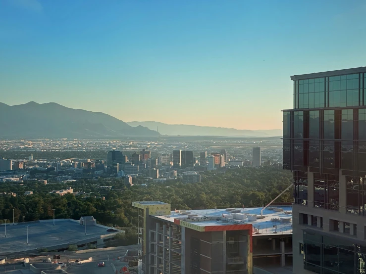 a high rise city view with mountains in the background