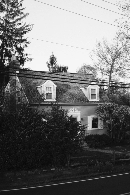 the sky is dark in front of a large house