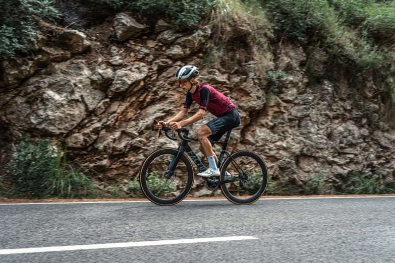 a man riding a bike down the side of a road