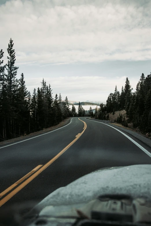 the front end of a car driving down a road