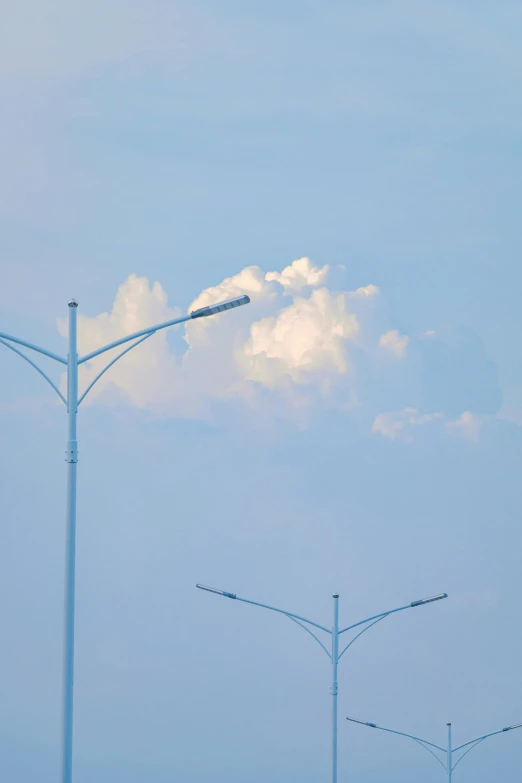 a street lamp on a pole that is near the road