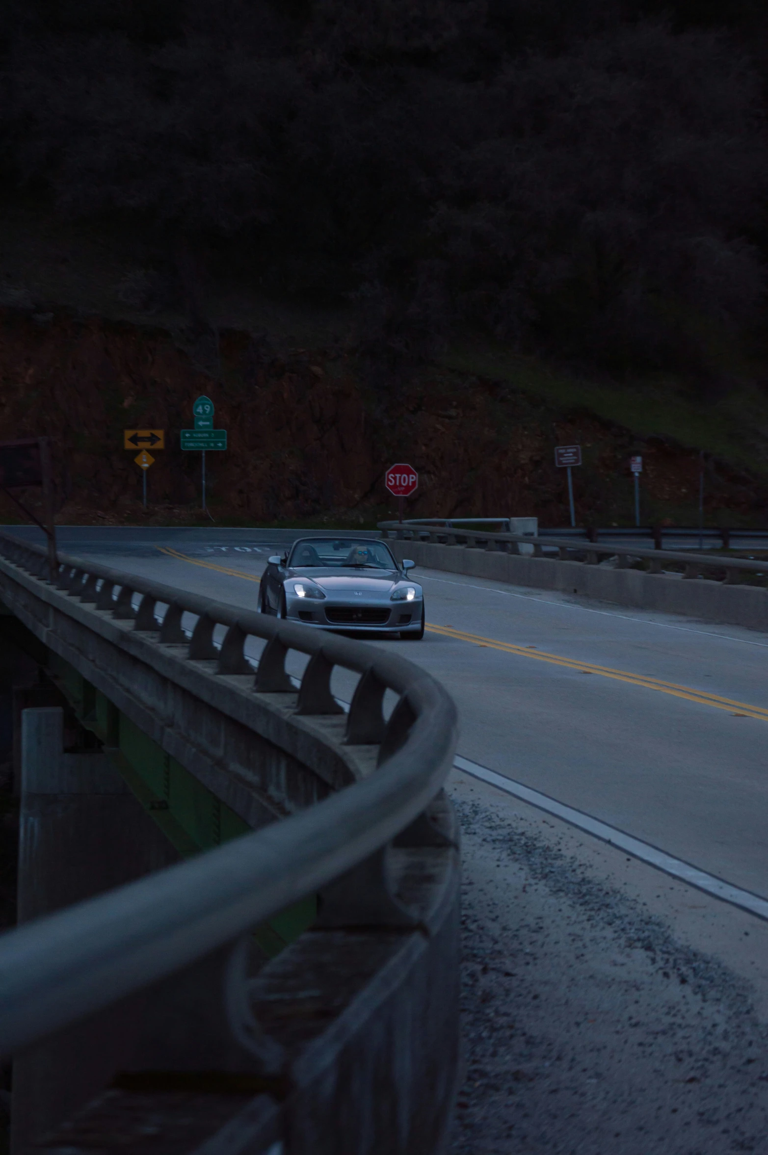 car driving down highway on rainy night