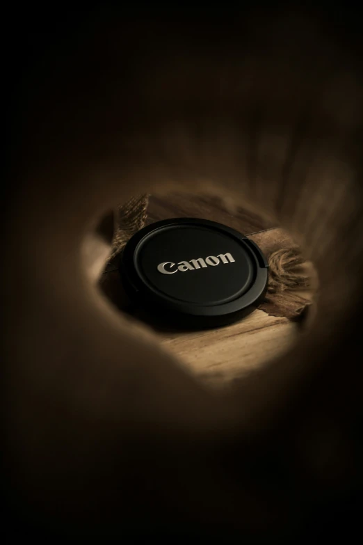 a wooden table with a black on that says canon
