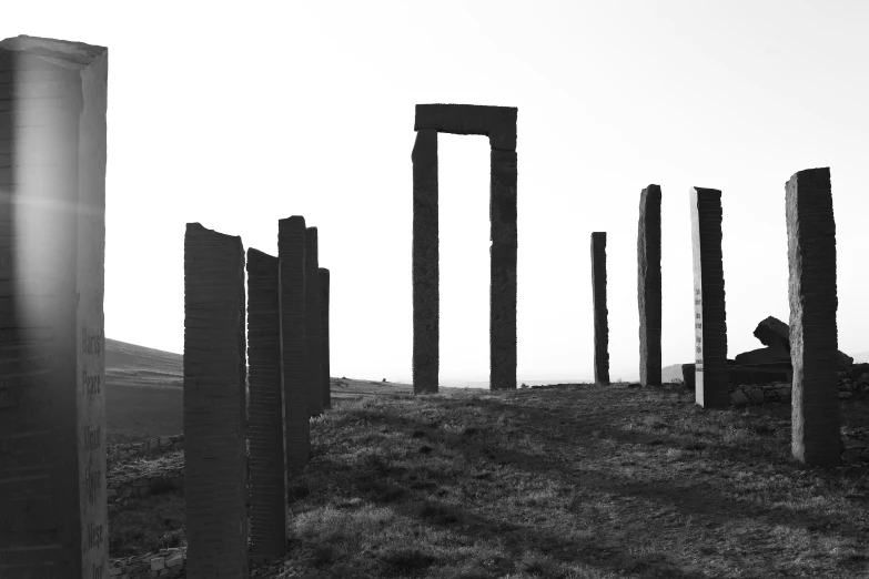 four tall metal posts sitting in the grass