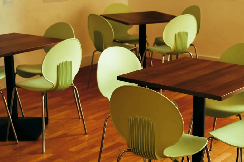 green chairs in a small meeting room with a wooden table