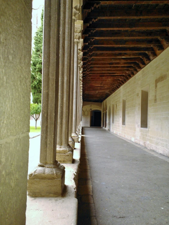 columns with carved figures on the side by the road