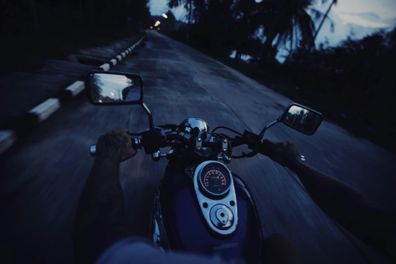 a motorcycle riding down the street at night