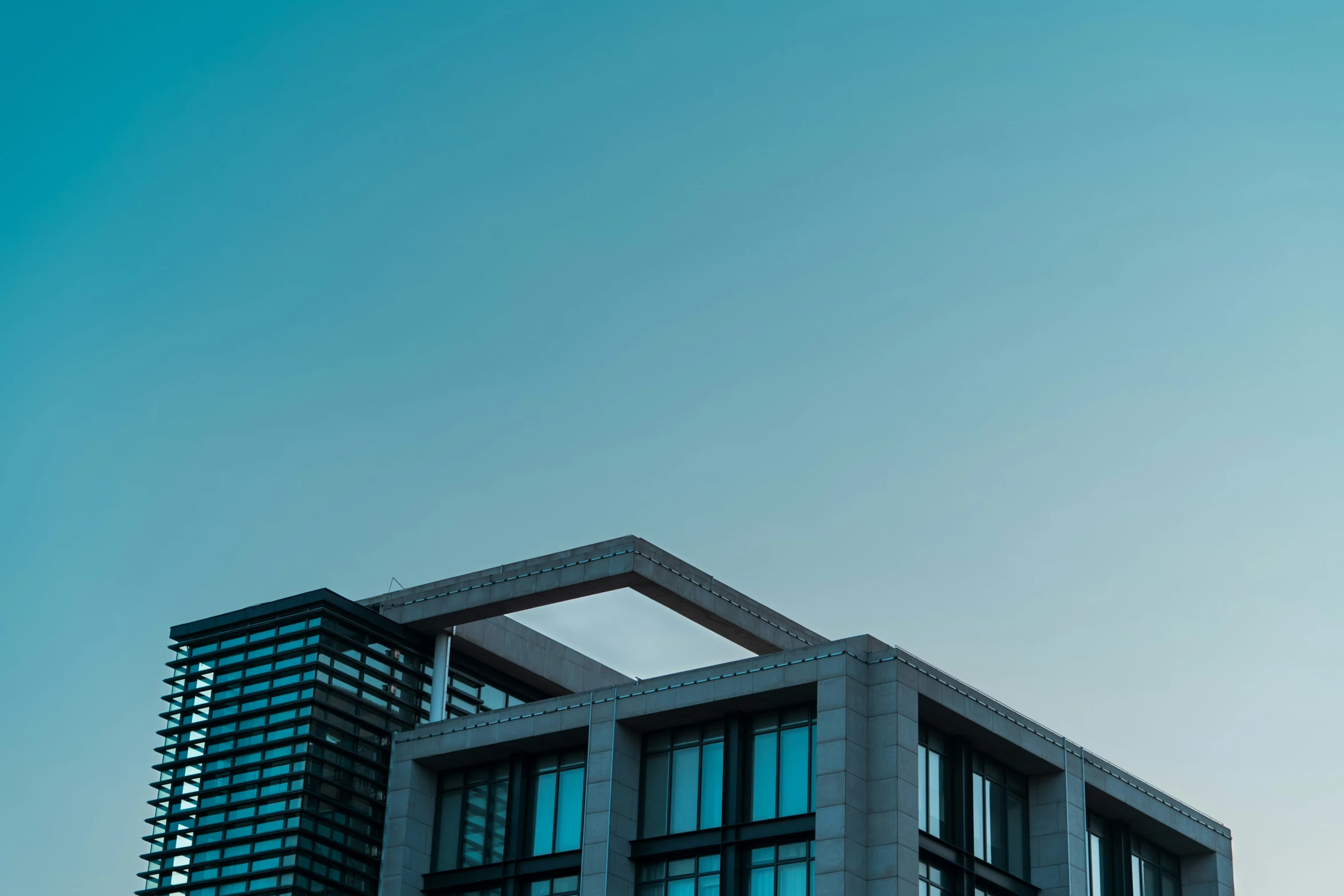 a tall building with windows against a blue sky