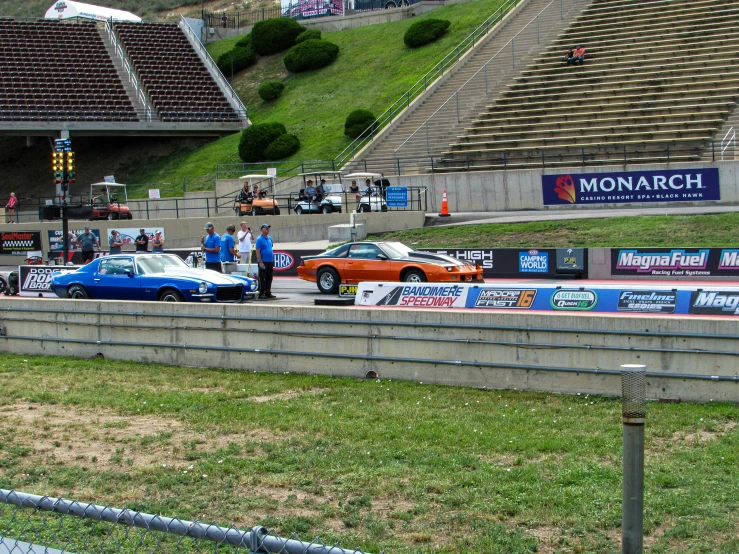 a couple of cars are parked near some stands