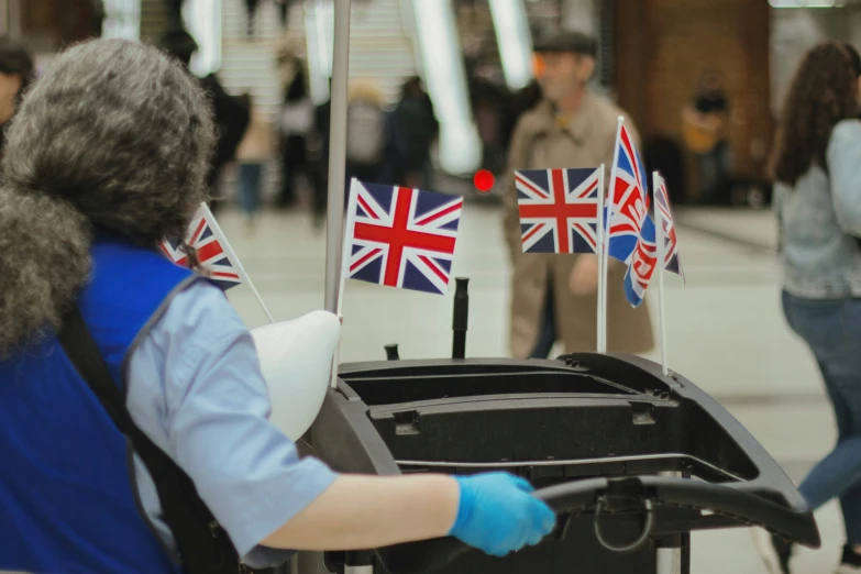 a woman in a wheelchair with british flags on it