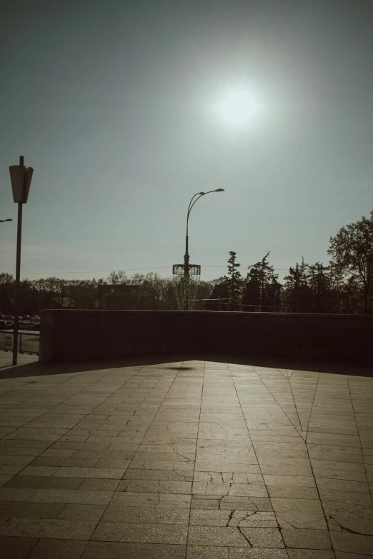 the sun shines brightly in the blue sky above a stone wall