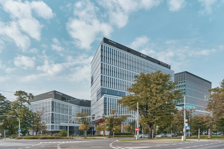 a large building with a blue sky and clouds in the background