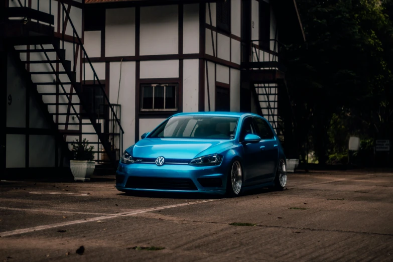 a blue golf car parked in front of an older building