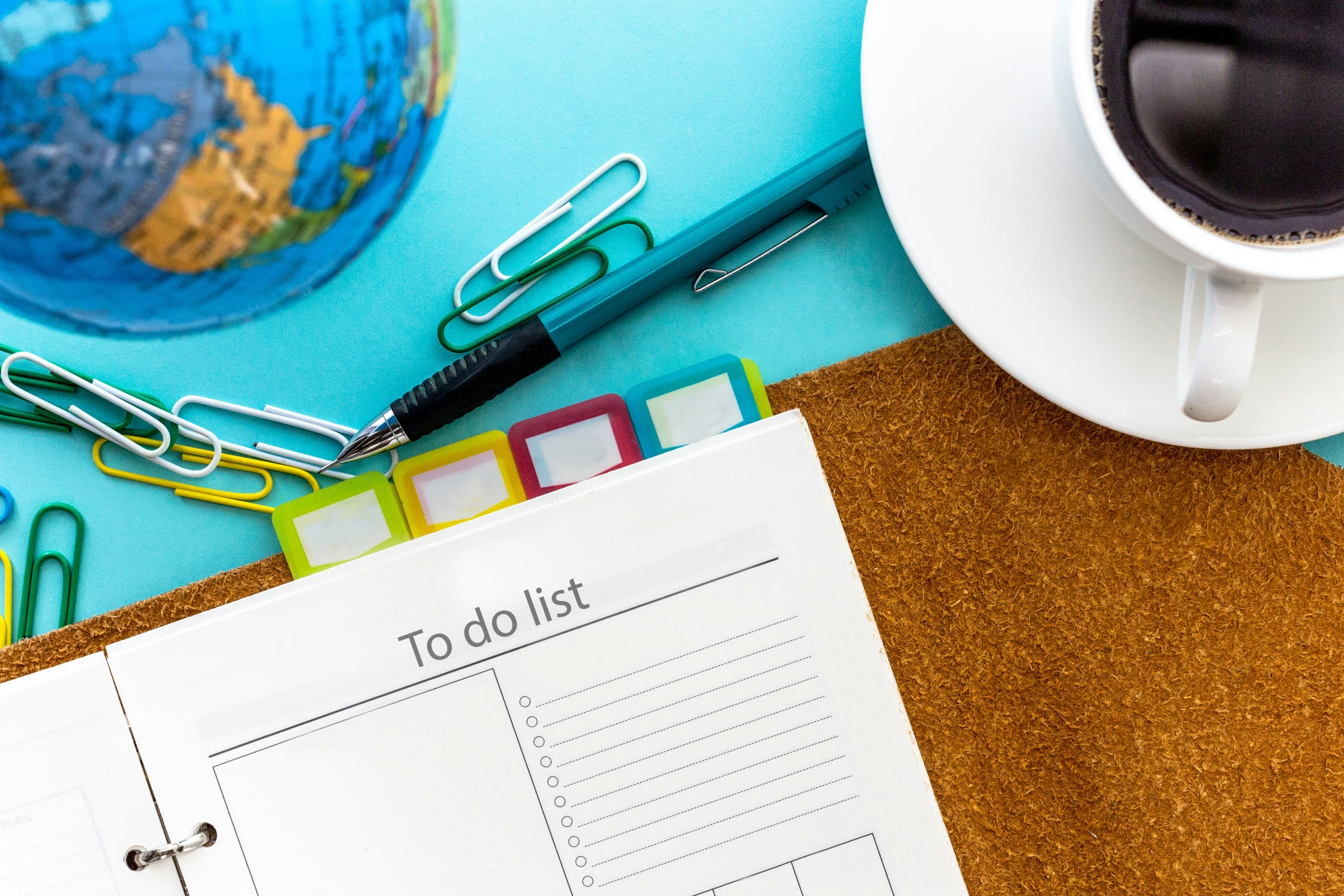 a notebook on a desk with several different items