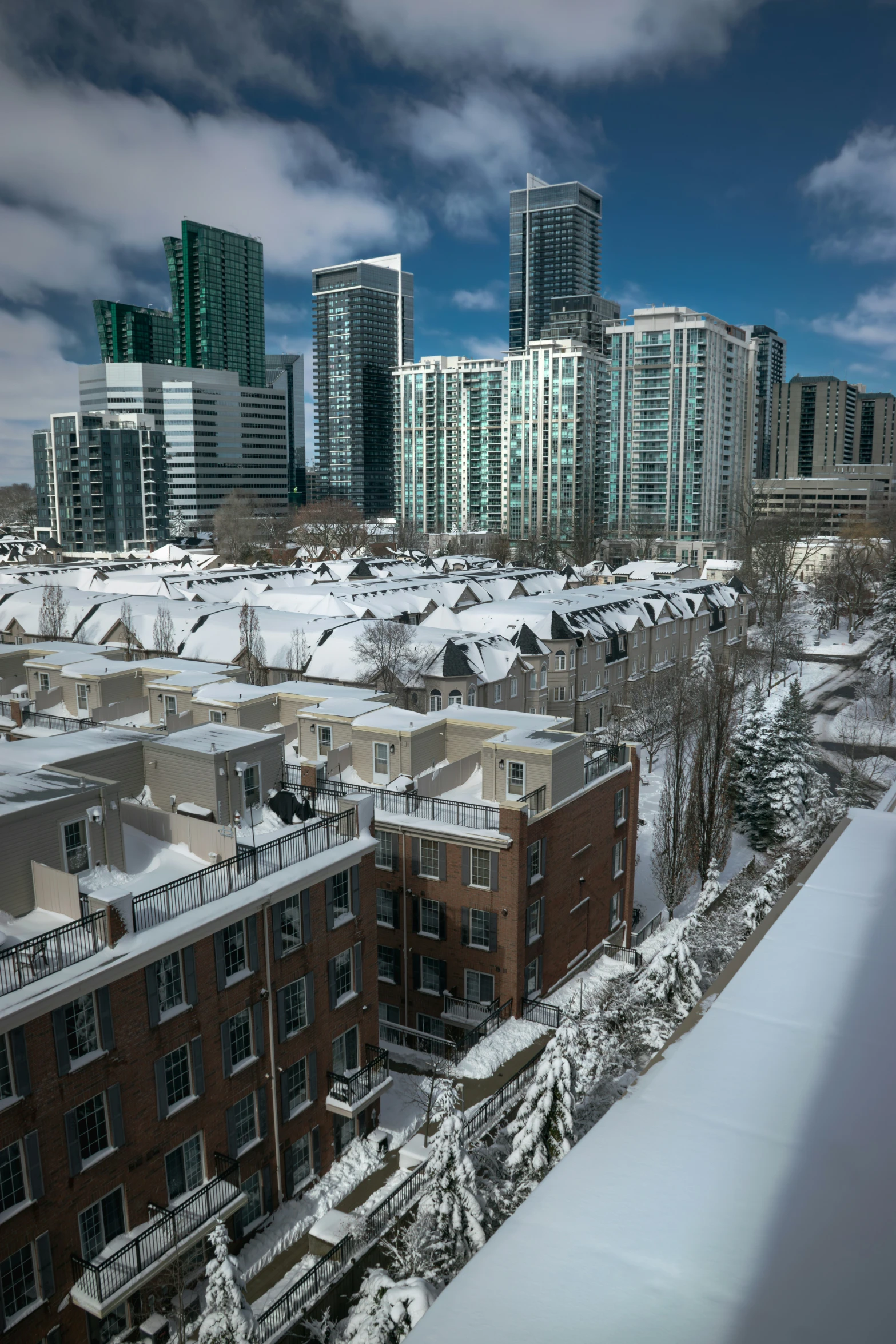 view of a snowy area in the city with high buildings