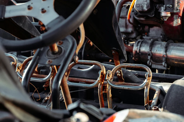 large metal pipes connected with chains sit inside a small engine