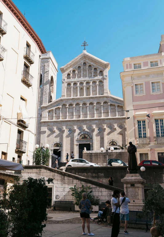 people are walking outside of an old church