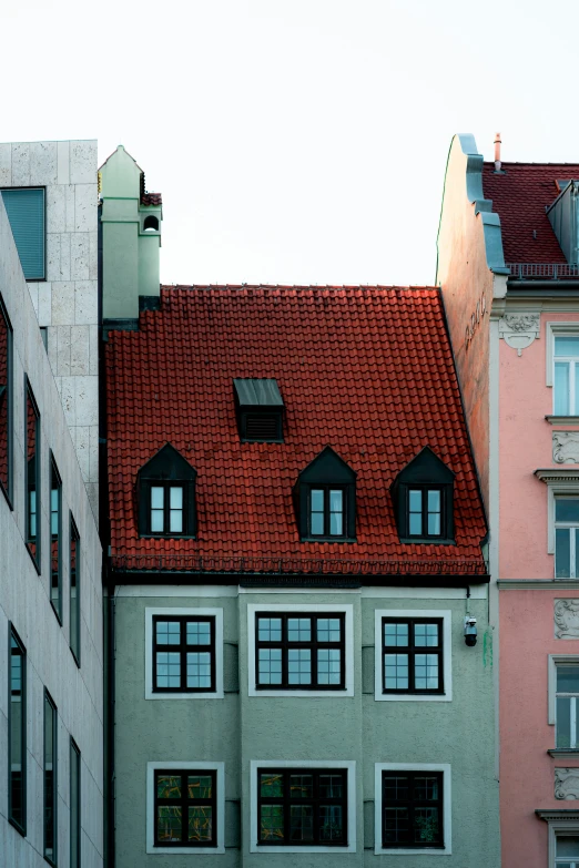 there is a tall, three story building with a red roof