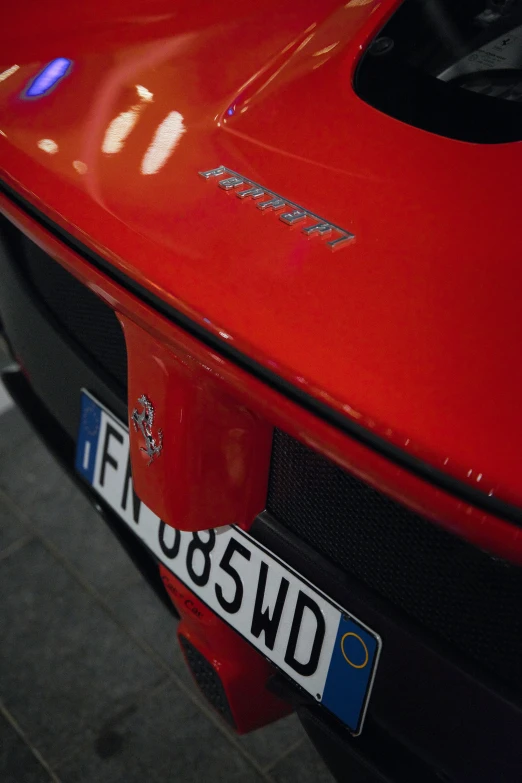 a close up s of the front end of a red porsche