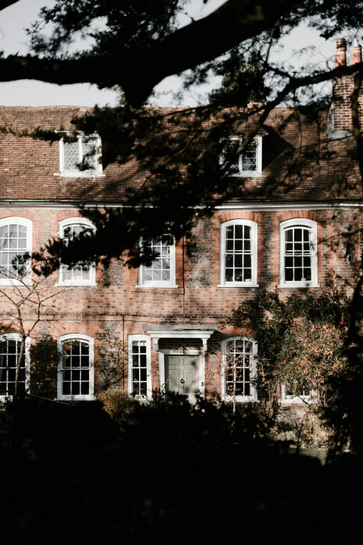 a red brick building with many windows and a clock