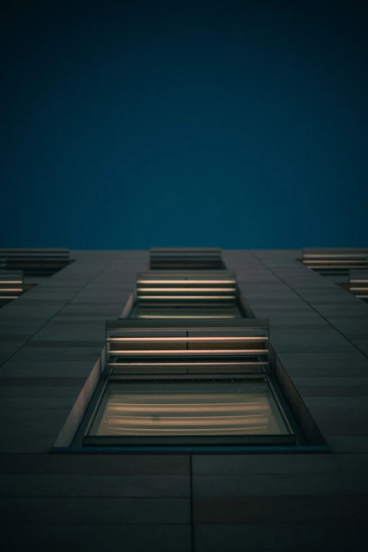 three stairs are standing against the building with their lights on