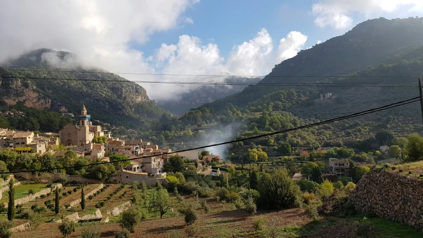 a small village sits at the edge of some mountains