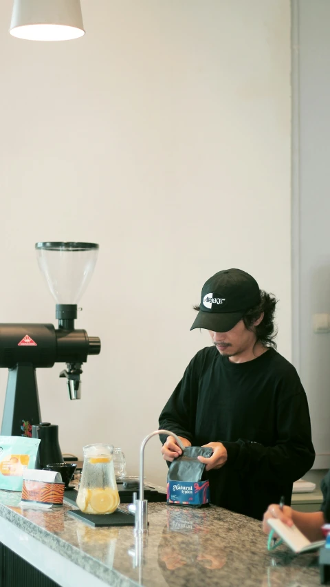 young man standing by counter and looking at camera