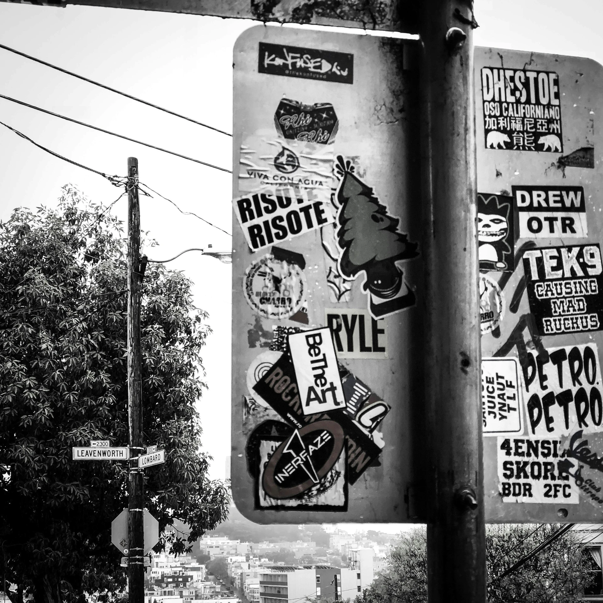 a black and white po of street signs in the sun