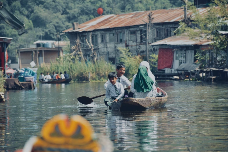 two people in a small boat with paddles