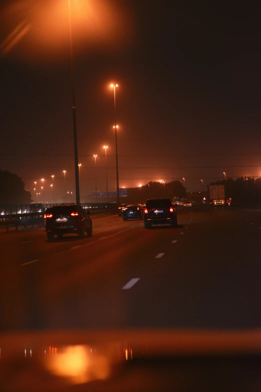 the lights of the lights on the buildings shine over the freeway