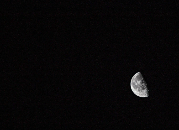 the moon is seen from behind a satellite vehicle