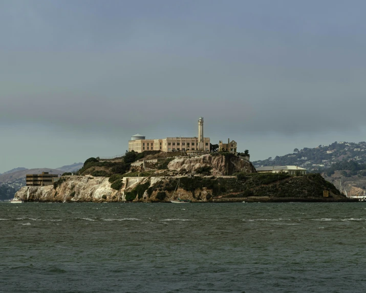 a large white building is on a mountain