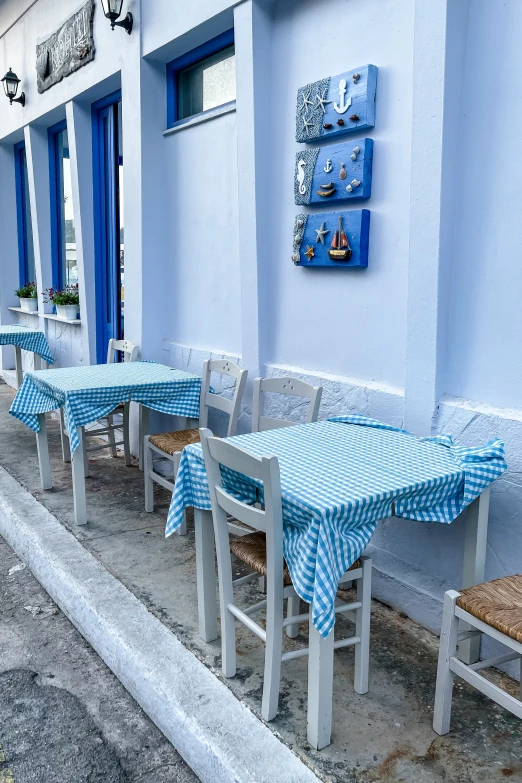 blue and white tables and chairs with tables outside