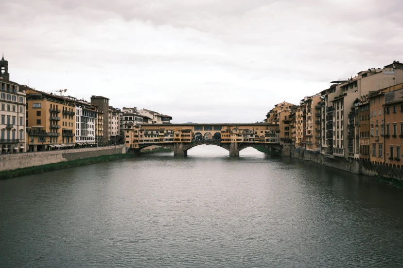 a couple of bridges across a river next to tall buildings