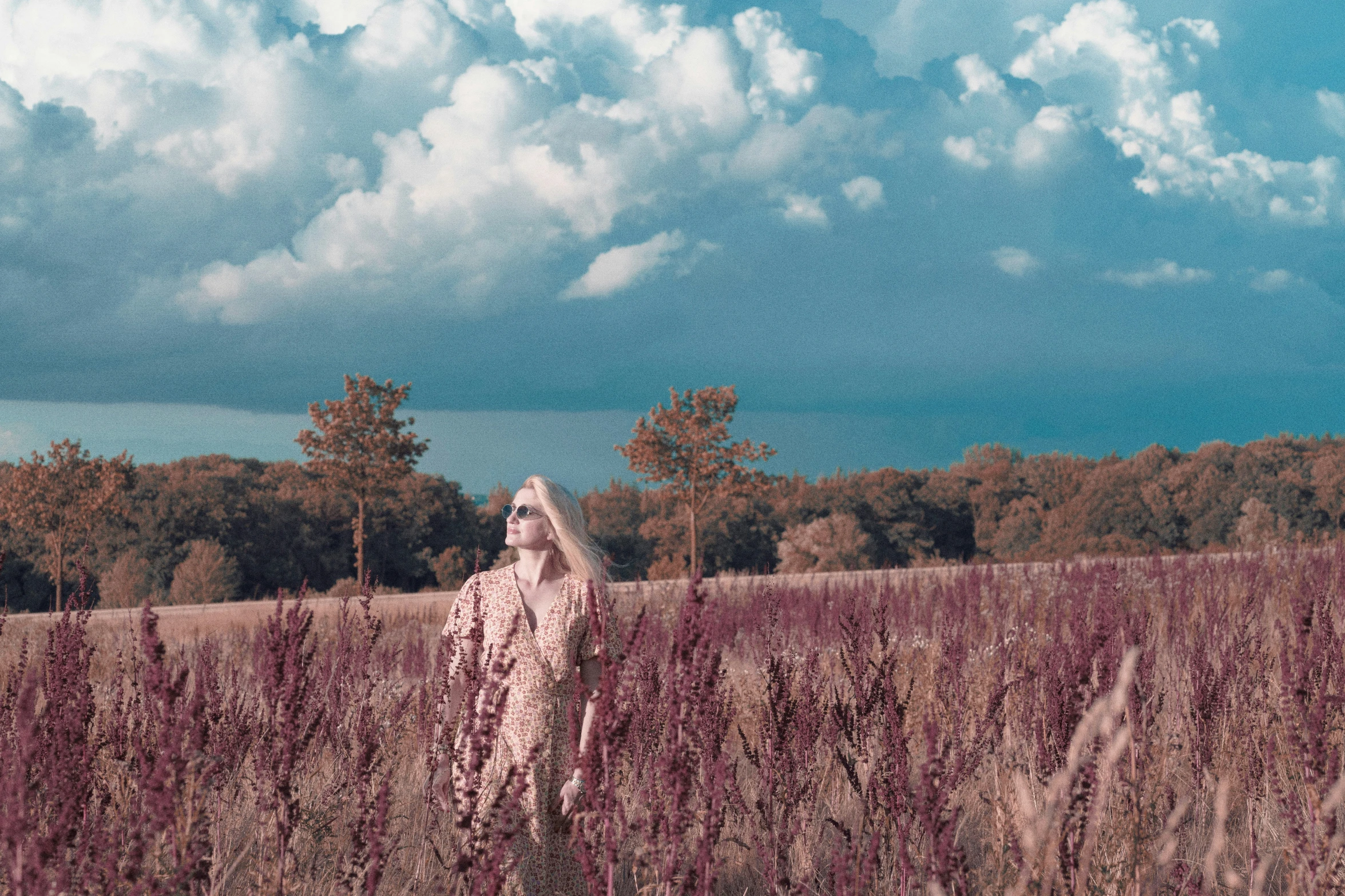 a woman in a field that is very tall